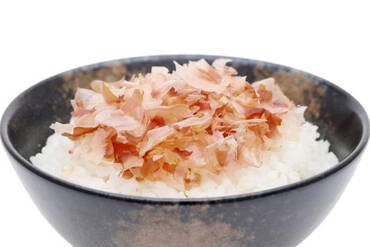 Japanese food, Katuobushi on cooked white rice on white background